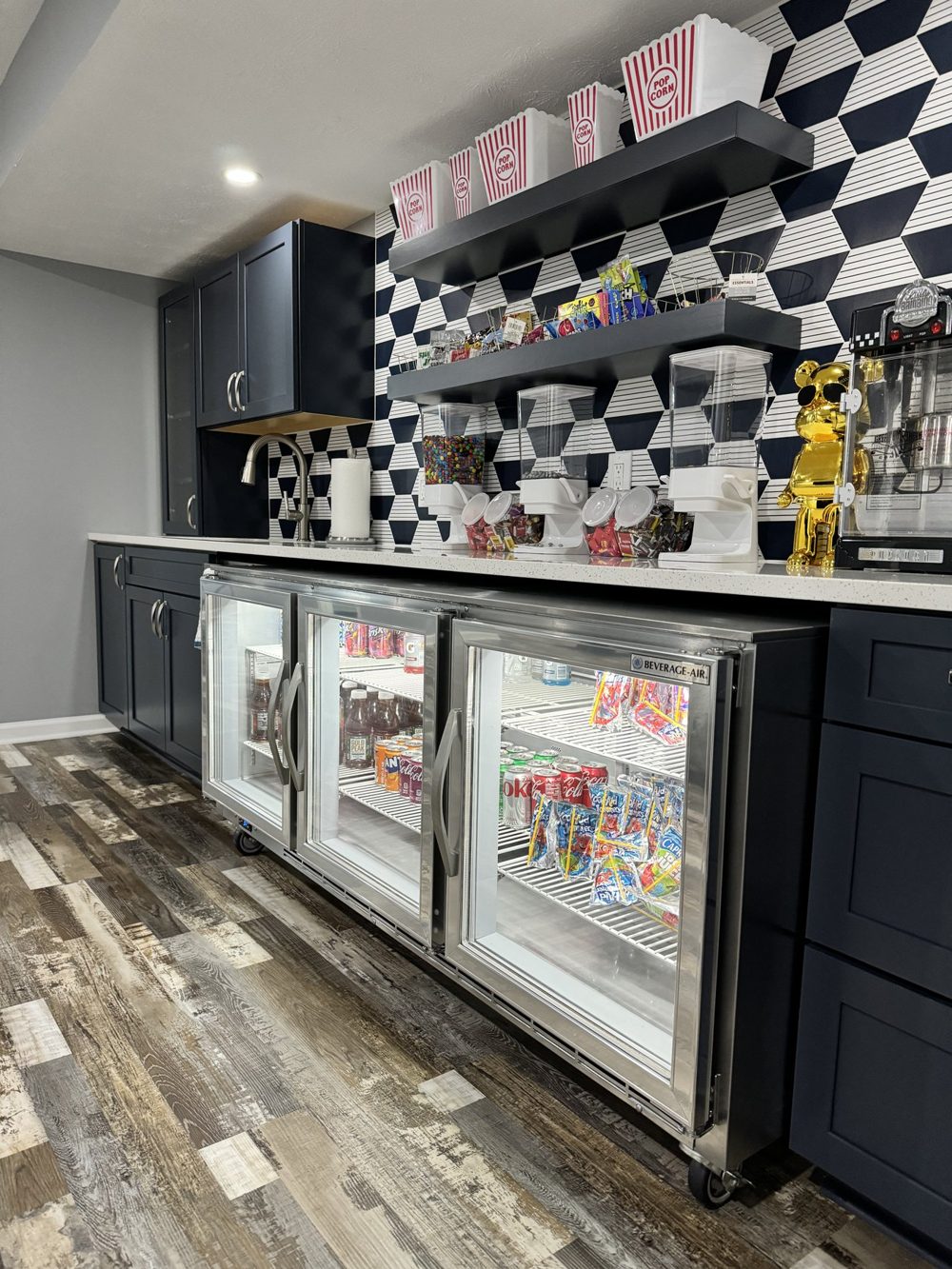 Basement bar with checkered tile, beverage coolers and dark cabinets