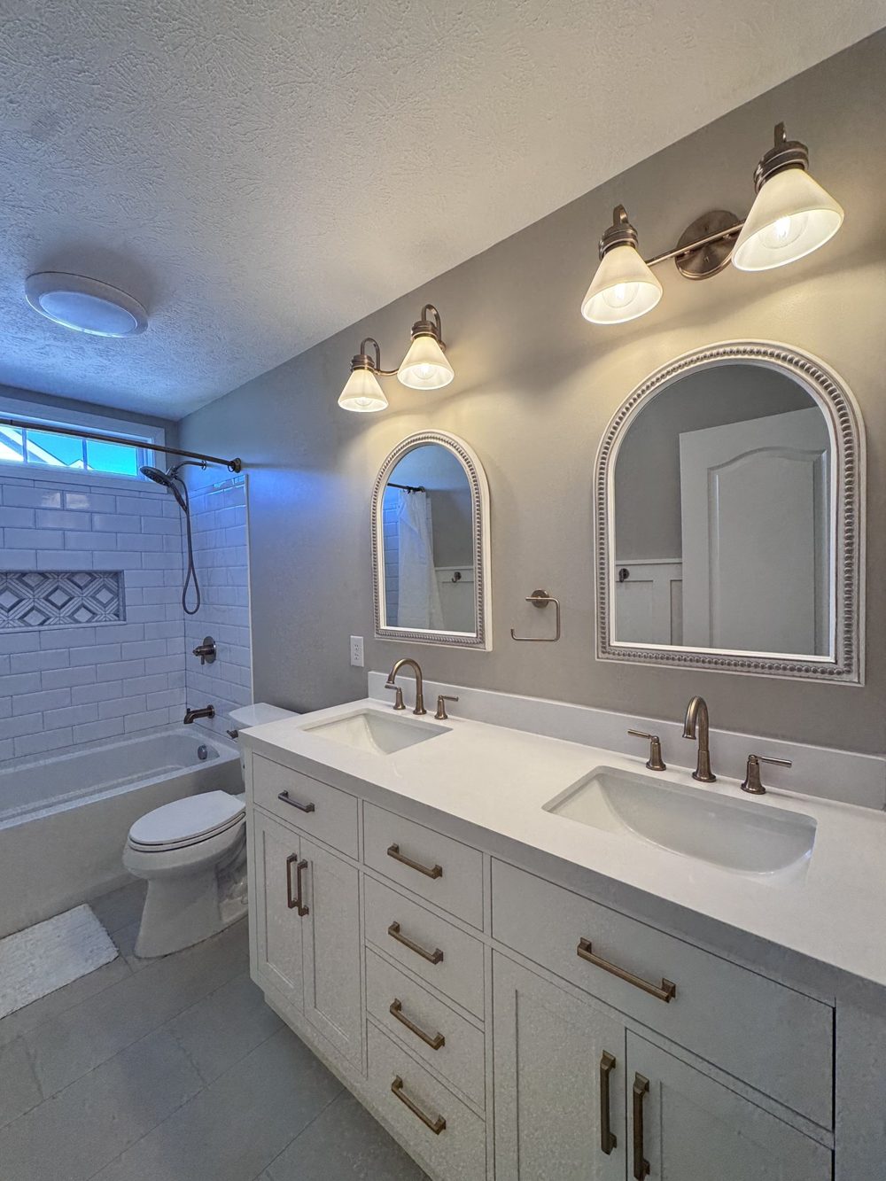 Bathroom with arched mirrors and a long double vanity