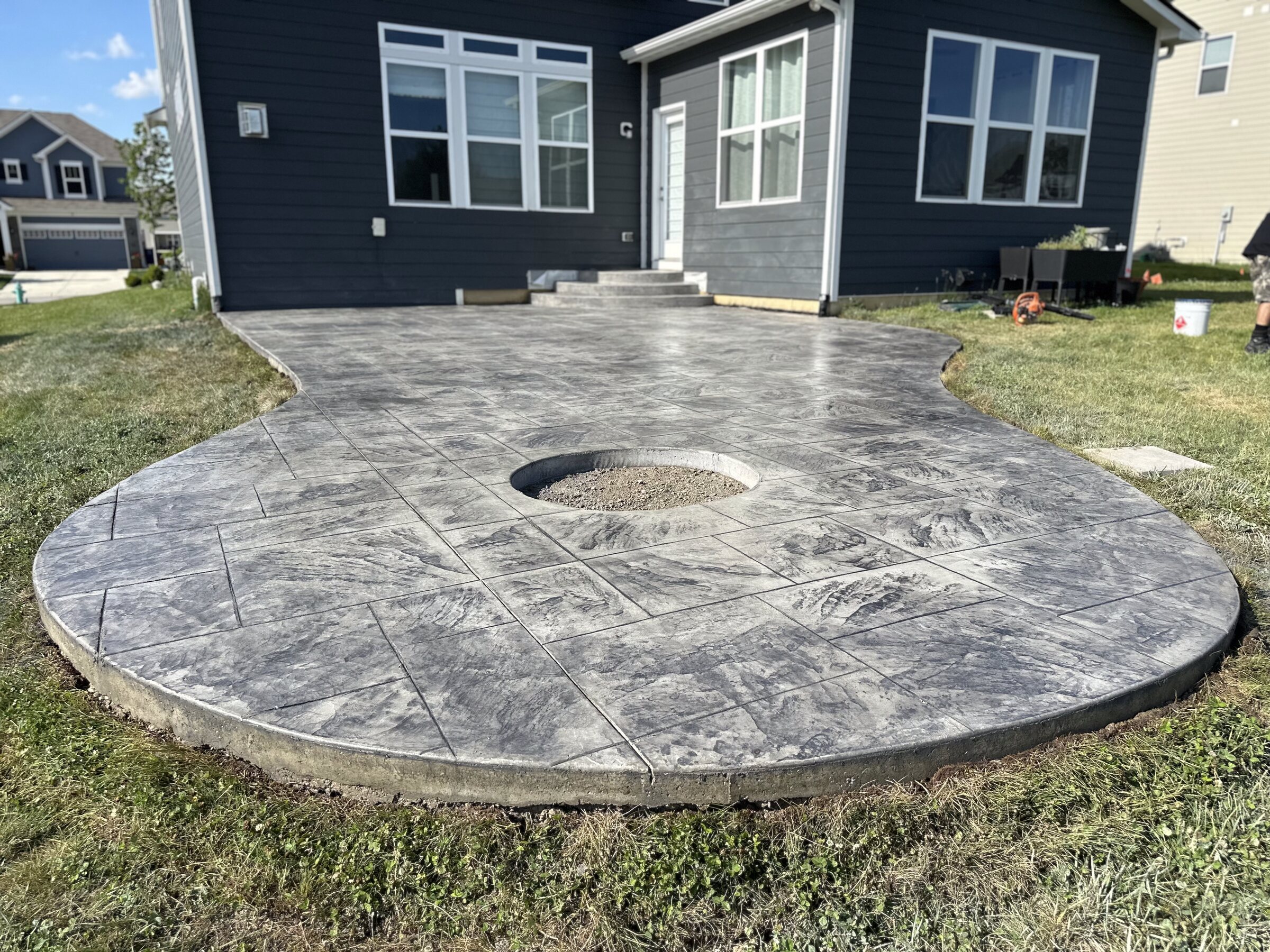 Round stamped patio with a recessed fire pit ring